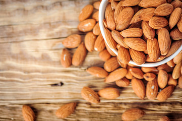 Top view of almonds on wooden table. Almonds nuts concept.