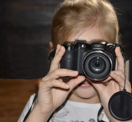 Favourite hobby. The camera is in the hands of a pretty girl.