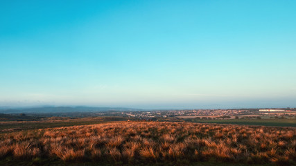 Fototapeta na wymiar Panorama of the Scottish summer countryside on sunset. West Lothian, Scotland