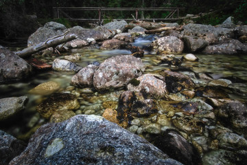 Flowing mountain stream with stones