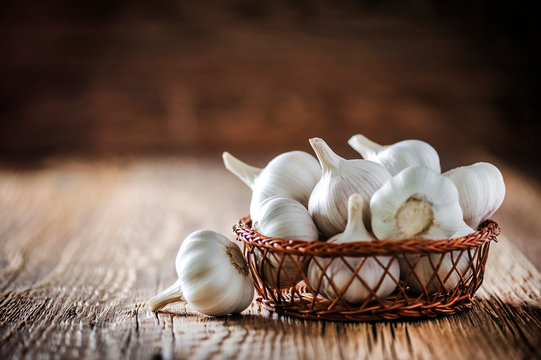 Garlic. Fresh garlic in wooden basket. Pile of garlic cloves.