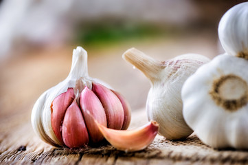 Fresh garlic on vintage table. Garlic cloves. Peeled garlic bulbs on jute.
