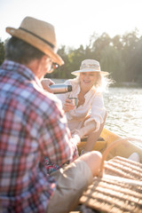 Couple enjoying boat trip drinking tea and watching sunset