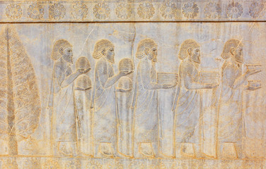 Image of assyrian warriors with spears in their hands. Ancient reliefs on the ruined walls of the Persepolis. Persepolis. Iran.