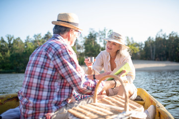 Couple drinking hot tea while having amazing boat trip together