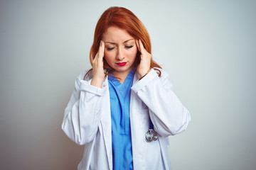 Young redhead doctor woman using stethoscope over white isolated background with hand on headache...