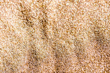 Gold background. Golden glitters for graphic design. Gold sand