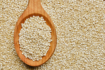 quinoa seeds in wooden spoon. quinoa seeds background