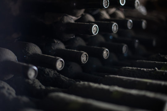 Old dusty wine bottles in a dark basement