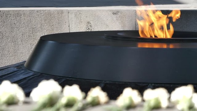 Close up of the Eternal Flame of Armenian Genocide Memorial. Yerevan. Pan right