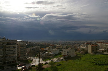 City after the summer storm, with the sun breaking through the clouds