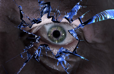 One eye looks through a splintered glass. Concept: curiosity and espionage