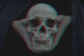 Close-up of glitched skull held in hands