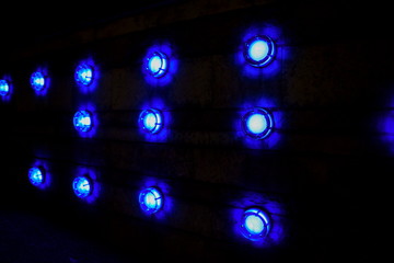 Round blue lamp, on dark background. closeup.