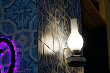 Decorative kerosene lamp in cafe. Gasoline lamp on wall indoor cafe