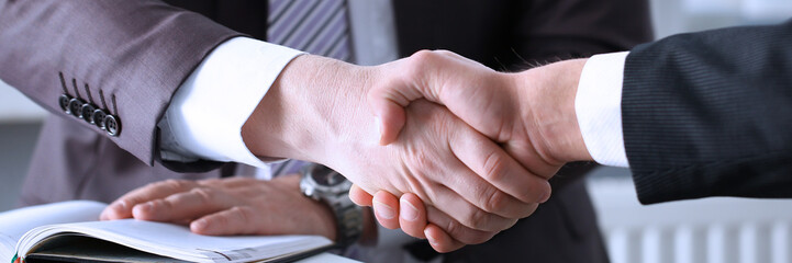 Man in suit shake hand as hello in office closeup. Friend welcome mediation offer positive introduction greet or thanks gesture summit participate approval motivation strike arm bargain concept