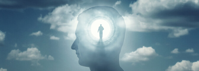 A silhouete of a man with rays of light emanating from the brain as a symbol of the power of...