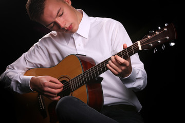 Young men playing the guitar