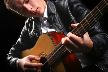 Fototapeta premium Young men playing the guitar