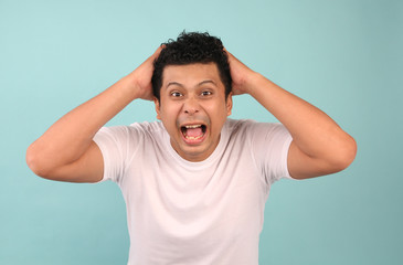 Portrait of a young Asian man Disappointed, focusing on men in White T-shirts On a blue background.