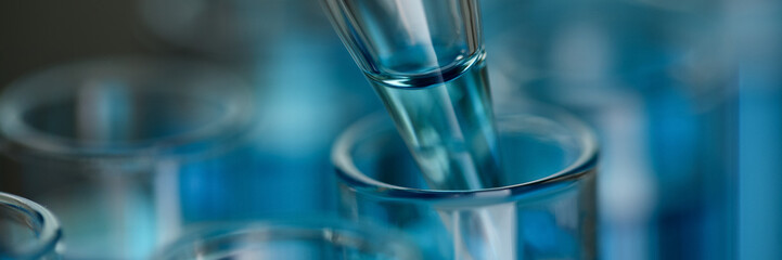 Test tube of glass overflows new liquid solution potassium blue conducts an analysis reaction takes various versions reagents using chemical pharmaceutics cancer manufacturing .