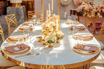 Served table at a wedding party. Warm sunlight on the festive table.