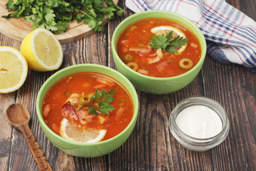 Two bowls with traditional Russian soup solyanka	