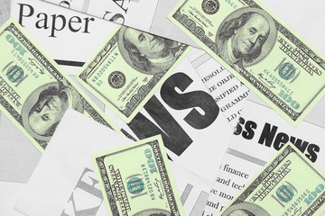 Newspapers and Money. One Hundred Dollar Bills and News Pages with Headlines and Articles Scattered on Table, View from Above. Business Background or Finance Concept