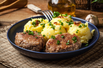 Meatballs served with boiled potatoes.