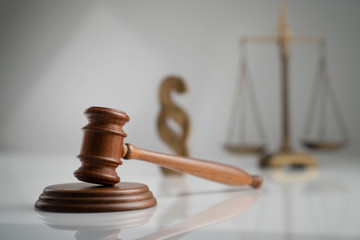 Judge antique gavel and scale - law and justice symbols on white table and background.