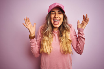 Young beautiful woman wearing cap over pink isolated background celebrating mad and crazy for...