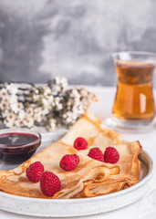 Tasty pancakes with fresh raspberries.