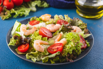 Delicious seafood salad with shrimps and fresh vegetable salad. Healthy  and diet food.