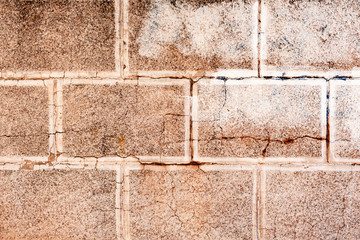 Texture of a brick wall with cracks and scratches which can be used as a background
