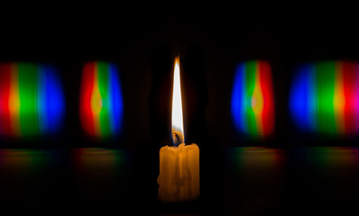 Photo diffraction candle flame light in the form of iridescent spots