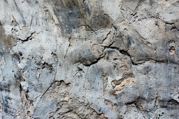 Texture of a concrete wall with cracks and scratches which can be used as a background