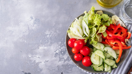 Assorted of fresh vegetables on a plate. Healthy food concept. Top view. Copy space