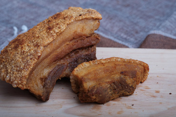 Thai crispy skin pork belly on wooden board