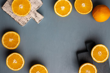 Top view half cut oranges frame on table