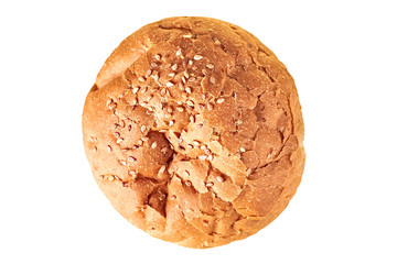 One tasty soft fresh whole round bun with sesame for hamburger, cheeseburger or cooking other burgers. Isolated on white background. Close-up. Top view