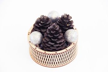 Christmas natural brown cones on the tree in a wooden basket for the New Year holiday