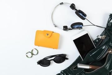 Fashion concept : Flat lay of leather woman bag open out with sunglasses and smartphone on white background. - Image