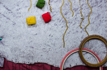Composition on fabric from frames and threads. Colored threads on a fabric background. Embroidered with sequins fabric. copy space, top view, flat lay, background with blank space for text