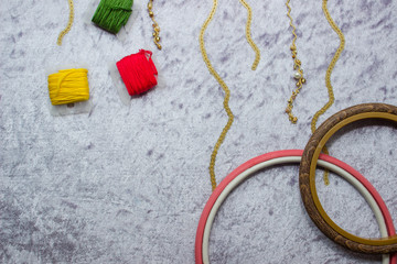 Composition on fabric from frames and threads. Colored threads on a fabric background. Embroidered with sequins fabric. copy space, top view, flat lay, background with blank space for text