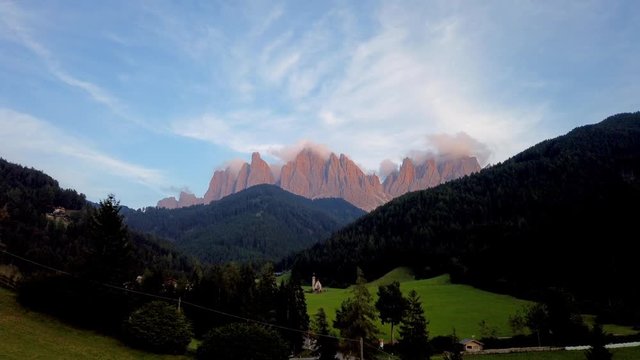Timelapse Dolomite view of Valle di Funes with San giovanni in Ranui church and Puez Geisler naturepark peaks at sunset