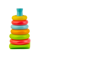 Plastic toy pyramid on a white background. Games and Copy space concept