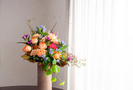 Flower arrangement on a windowsill : Rose, Gentian, Carnation, Stemona japonica	