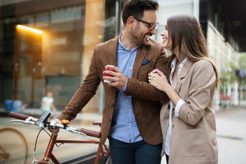 Happy business colleagues talking and walking in the city outdoor