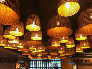 original room lamps in wicker shades with a pleasant warm light in a cozy rustic country style interior