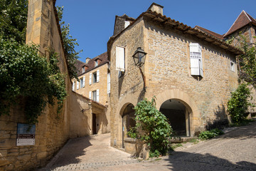 Fototapeta na wymiar Historic houses along Montagne street in Sarlat la Caneda in Dordogne Department, Aquitaine, France